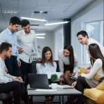 IT support professionals in a modern office analyzing cloud services Owosso architecture across multiple monitors.
